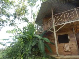 a tree house with a chair in front of it at Tierra Madre Eco Lodge in Los Andes +11 photos