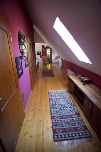an attic hallway with a wooden floor and purple walls at Willa Ranczo in Kończyce Wielkie