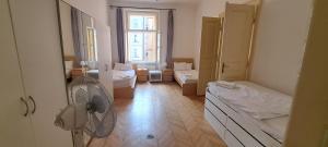 a room with a room with two beds and a fan at Apartments in Mala Strana - 10 minutes from Charles Bridge in Prague