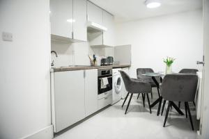 a kitchen with a table and chairs in a room at 1B Apartment, 30 mins to Oxford Street in London