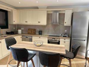 a kitchen with a table with chairs and a refrigerator at Moudros Sunset in Moúdhros +19 photos