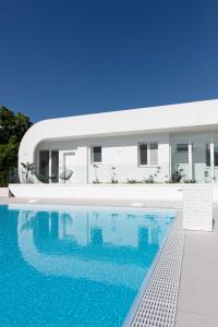 a house with a swimming pool in front of it at Stellaris Apartrooms in Termoli