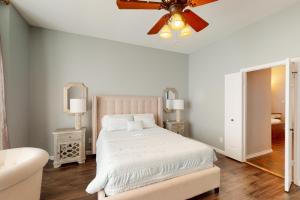 a white bedroom with a bed and a ceiling fan at Lake Ray Hubbard Retreat in Rockwall +21 photos