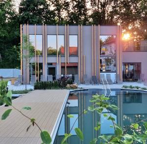 a house with a pool in front of a building at Vitalhotel Bad Birnbach in Bad Birnbach
