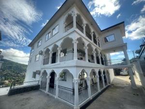 a white building with a balcony and a blue sky at After 5 Apartment 2 3 spacious en-suite bedrooms in Freetown