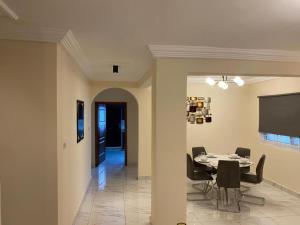 a dining room with a table and chairs at After 5 Apartment 1- 3 spacious en-suite bedrooms in Freetown