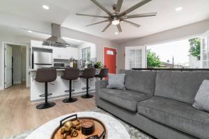a living room with a couch and a kitchen at A Place to Create Lasting Family Memories in San Diego