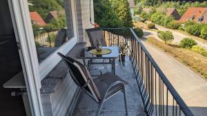 a patio with a table and chairs on a balcony at Ferienhaus Kusel Blick in Kusel