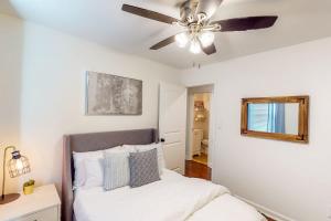 a bedroom with a ceiling fan and a bed at Bowers Bungalow in Atlanta