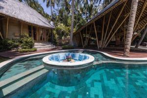 ein Pool vor einem Haus in der Unterkunft Harmony House, Bamboo House with Pool view in Bringkit