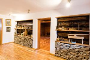 a room with a stone wall with shelves at Pensiunea Casa Bunicilor in Mănăstirea Humorului