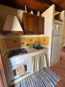 a kitchen with a stove and a sink at Casa a San Vito Lo Capo con giardino in San Vito lo Capo