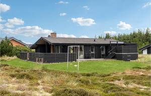 a house with a large yard in front of it at Amazing Home In Hvide Sande With 3 Bedrooms, Sauna And Wifi in Bjerregård