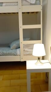 a white bunk bed with a lamp on a table at Casa rural Entre Dos Rios in Murillo de Río Leza