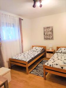 a bedroom with two beds and a window at Apartment Marina in Marina