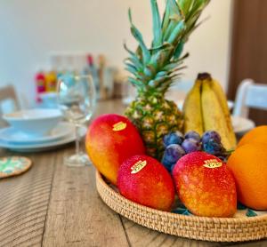 a bowl of fruit on a wooden table at Miyako Blue Villa Kugai in Miyako Island