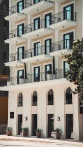 a building with balconies on the side of it at Kondo Hotel Allure in Budva