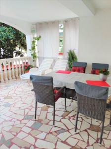 a porch with a table and chairs on a patio at Apartment Marina in Marina