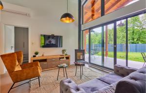 a living room with a couch and a table and a tv at Cozy Home & Spa In Nature in Trakoščansko Jezero