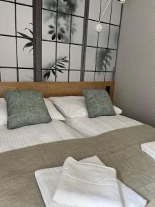 a bedroom with two beds with pillows on them at Apartamenty Skórzewo in Skórzewo