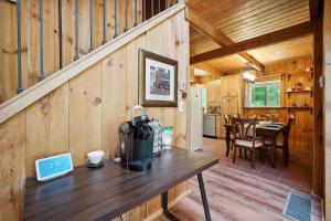 a kitchen and dining room of a wooden cabin with a table at Wilmington Vacation Rental Near Hiking and Skiing! in Wilmington