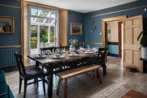a dining room with a table and chairs at The Cors Country House in Laugharne