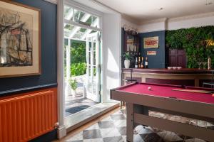 a billiard room with a pool table and a bar at The Cors Country House in Laugharne
