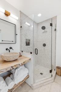 a bathroom with a glass shower and a sink at The Grand Canyon Headquarters in Valle