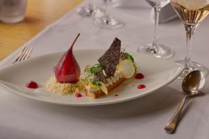 a plate with three desserts on a table at Gästehaus by Stoos Hotels in Stoos
