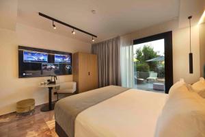 a hotel room with a large bed and a television at Boutique Hotel Sirmione in Sirmione +146 photos
