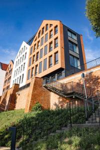 a building with a staircase in front of it at Spichlerz Malbork in Malbork