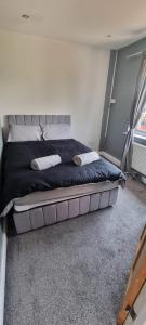 a bedroom with a bed with two towels on it at Thorpe House Suites in Heeley