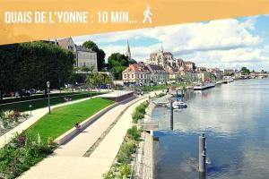 a view of a river in a city with buildings at LA BELLE PAUSE - Studio Auxerre proche parking in Auxerre +11 photos