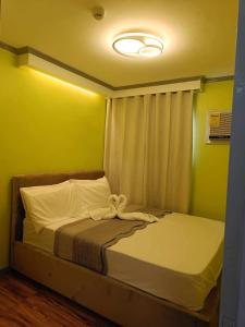 a bedroom with a bed with a bow on it at Davao condo unit 204 in Davao City