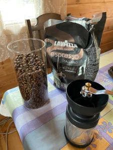 a table with a cup of coffee and a bag of coffee beans at Juniper holiday house in Kassari with sauna in Hiiumaa