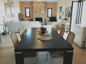 a black dining table with chairs in a living room at Las Home Upper Floor 