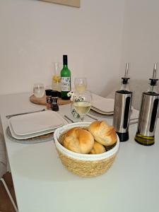 a table with a basket of bread and wine bottles at Gemütliche helle Ferienwohnung in Dresden