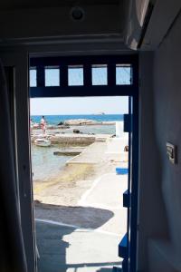 a view of the ocean from a doorway at il Marinero mandrakia in Mandrakia