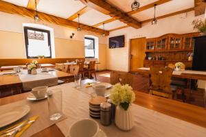 a dining room with wooden tables and chairs at Tourist farm Tominc in Brezje