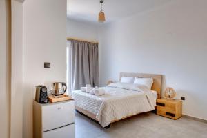 Ένα ή περισσότερα κρεβάτια σε δωμάτιο στο Aegean Glory Suites +44 φωτογραφίες