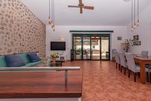 a living room with a couch and a table at Villa Nogues in Cala de Sant Vicenc