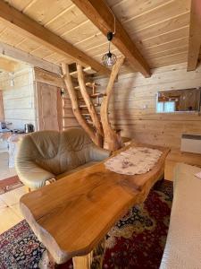 a living room with a wooden table and a couch at Domek Oźna płoscyna in Rajcza