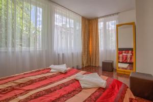 a bedroom with a bed and a large window at Veziova House in Bansko