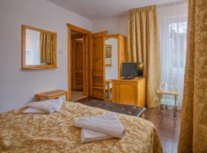 a bedroom with a bed with two towels on it at Veziova House in Bansko