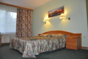 a hotel room with a bed and a window at West Hotel in Pereslavl-Zalesskiy