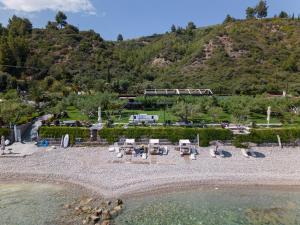 a view of a beach with a mountain in the background at Ktima Delmare Pantazara in Nea Skioni