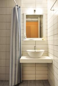 a bathroom with a sink and a mirror at Rea Hotel in Palaiochóra