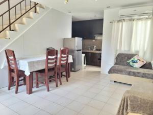 a kitchen and living room with a table and chairs at Blueming 2 Guesthouse Bayswater mactan THREE BEDROOM in Agus