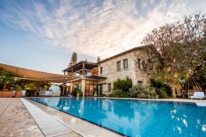 a large swimming pool in front of a building at Grand Vista Boutique Hotel And Spa in Yuval