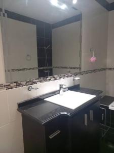 La salle de bains est pourvue d'un lavabo et d'un grand miroir. dans l'établissement La Casa de Los Mellis.., à La Banda
